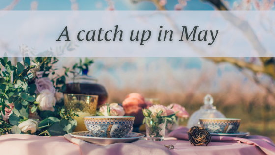 a table laid with pretty cups and saucers and other crockery, flowers, against a pretty countryside setting, and the words A catch up in May